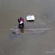 Archaeologist Niall Gregory inspects the submerged remnants of a logboat.